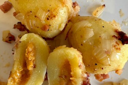 Golden brown gluten-free gnocchi filled with cheese and tomato